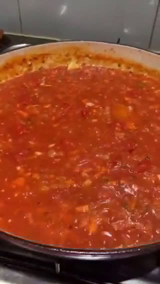 A picture of step 2 of Fregola sarda with prawns, squid, scallops, blue eye cod and light tomato sauce.