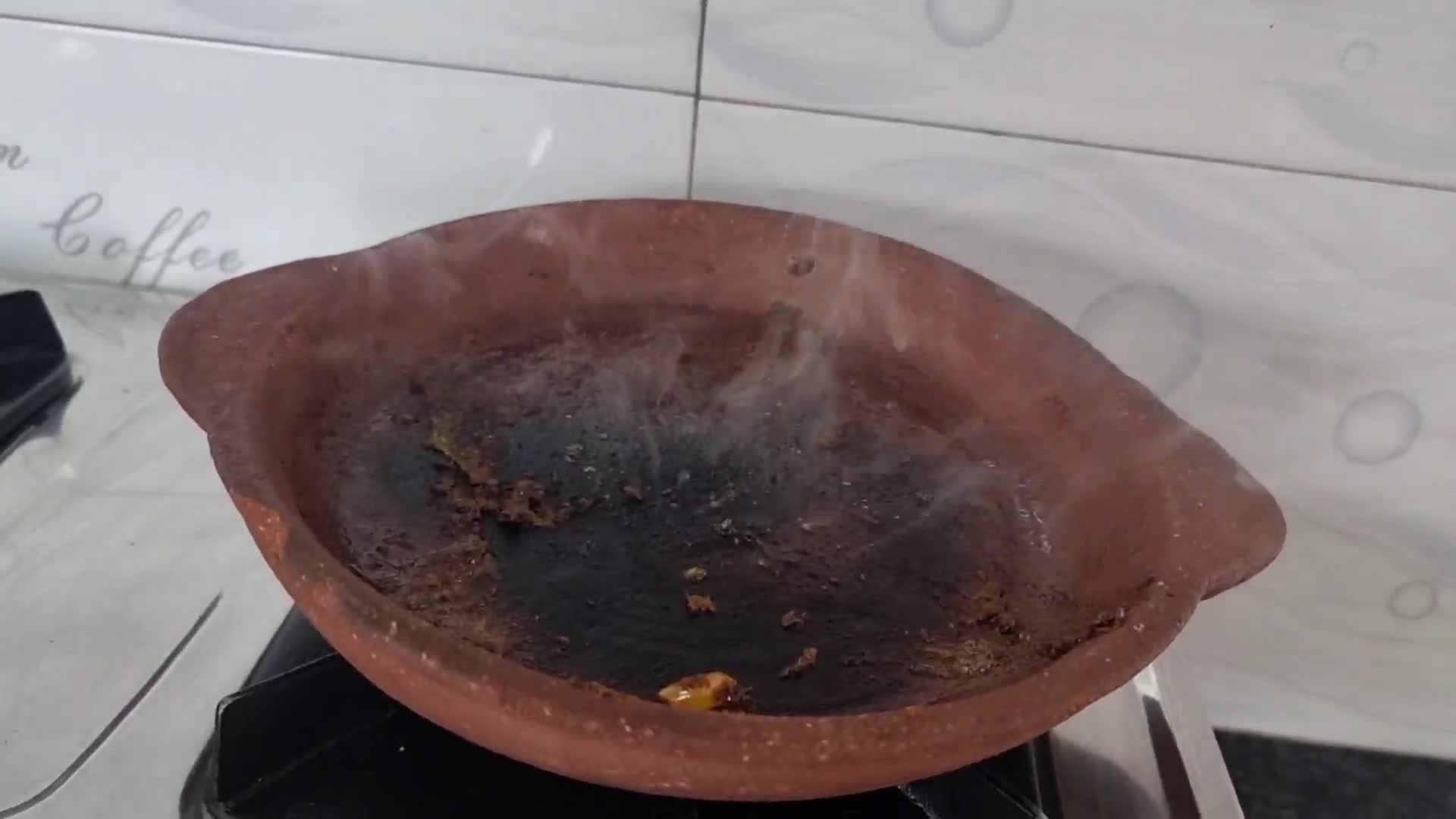 A picture of step 4 of Beans and rice sizzler in a clay pan.