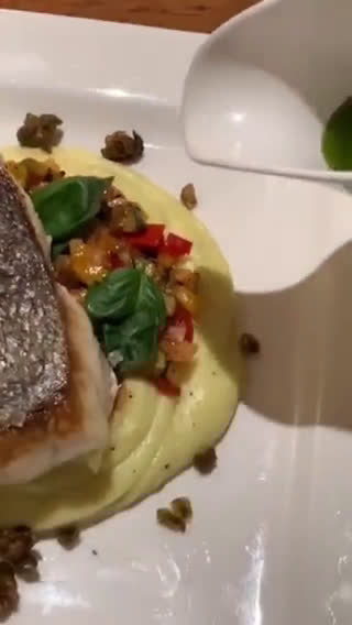 A picture of step 19 of Blue eye cod with caponata, Dutch creme mash, fried capers and served with basil and lemon oil.