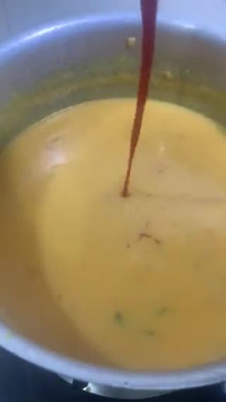 A picture of step 9 of Sweet and sour Tomato Curry serve with white rice.