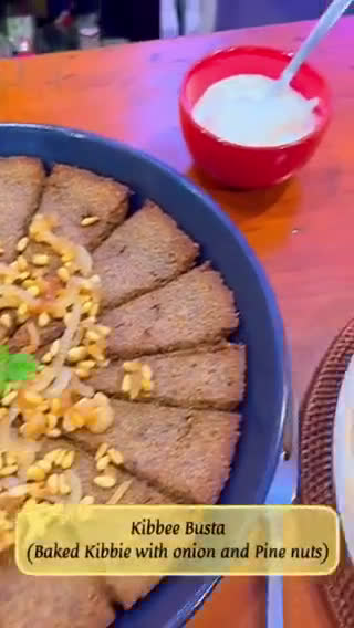 A picture of step 12 of Kibbee Busta (Baked Kibbee with onion and pine nuts).