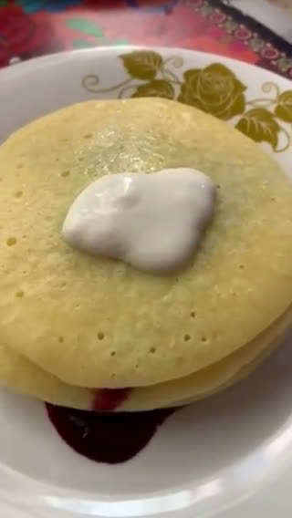 A picture of step 6 of Pancakes stack with Cherry sauce and cream cheese.