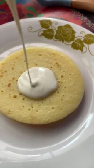 A picture of step 5 of Pancakes stack with Cherry sauce and cream cheese.