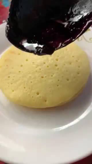 A picture of step 5 of Pancakes stack with Cherry sauce and cream cheese.