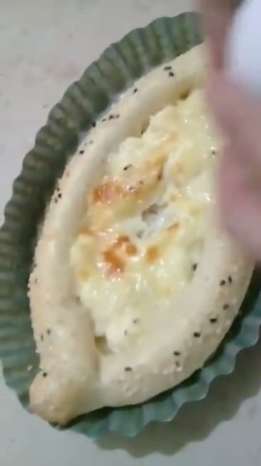 A picture of step 5 of Khachapuri with four cheese.